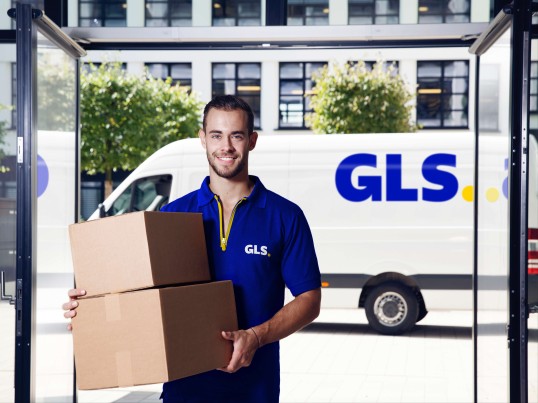 GLS Courier delivers a parcel to a shopkeeper