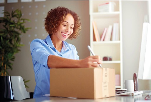 woman smiling and looking at a package