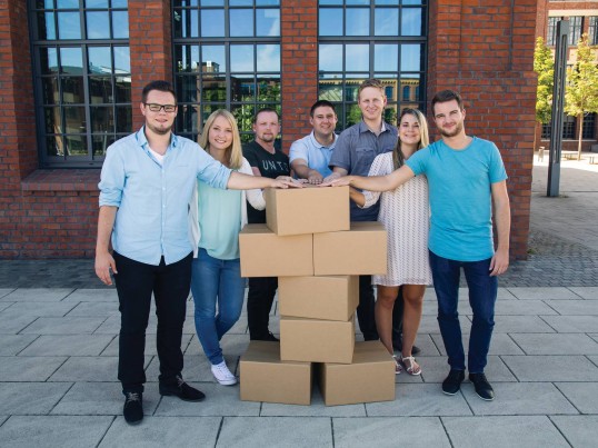 GLS employees holding a man made out of parcels