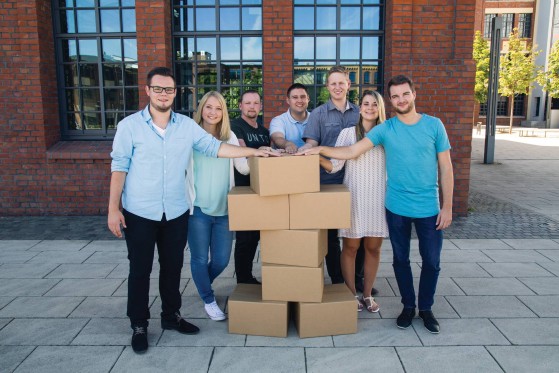GLS employees holding a man made of parcels