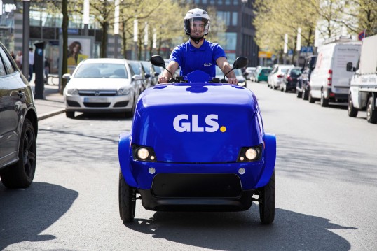 GLS courier making deliveries in city center with electric cargo bike