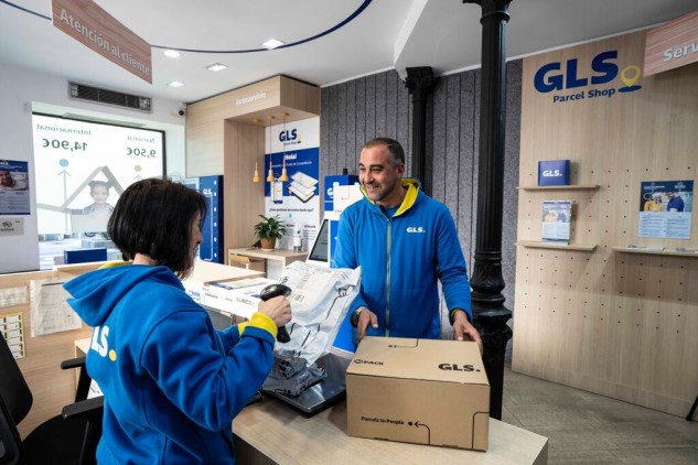 GLS staff in uniform organizing parcels in a Parcel Shop