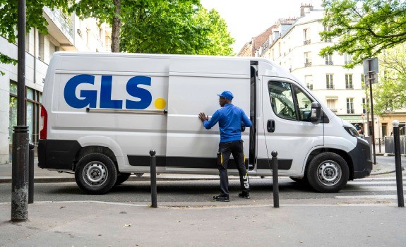 GLS delivery van with courier opening the side door during an urban parcel delivery route.
