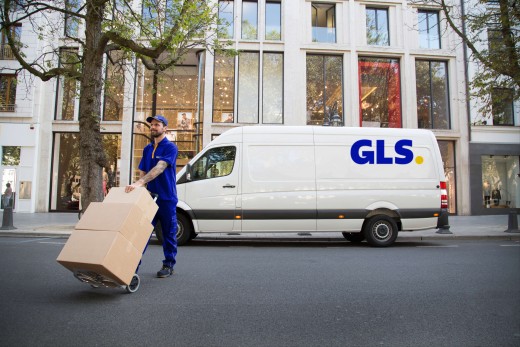 GLS delivery van driving on a forest road