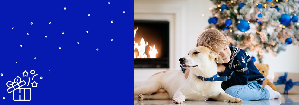 kid and dog in front of the christmas tree