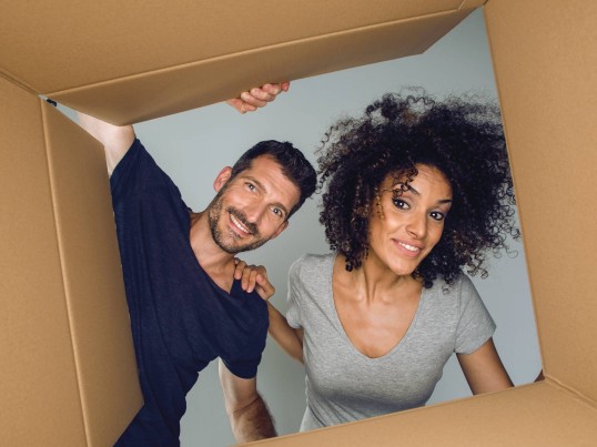 a woman and a man looking inside a GLS parcel