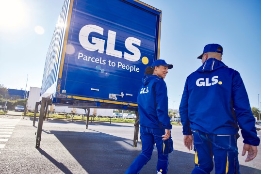 GLS employees outside at a depot and trailer