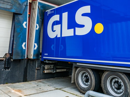 GLS delivery driver handing over a parcel