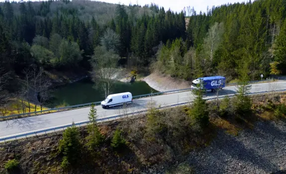 delivery van and truck on road 