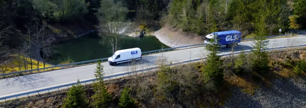 delivery van and truck on road 