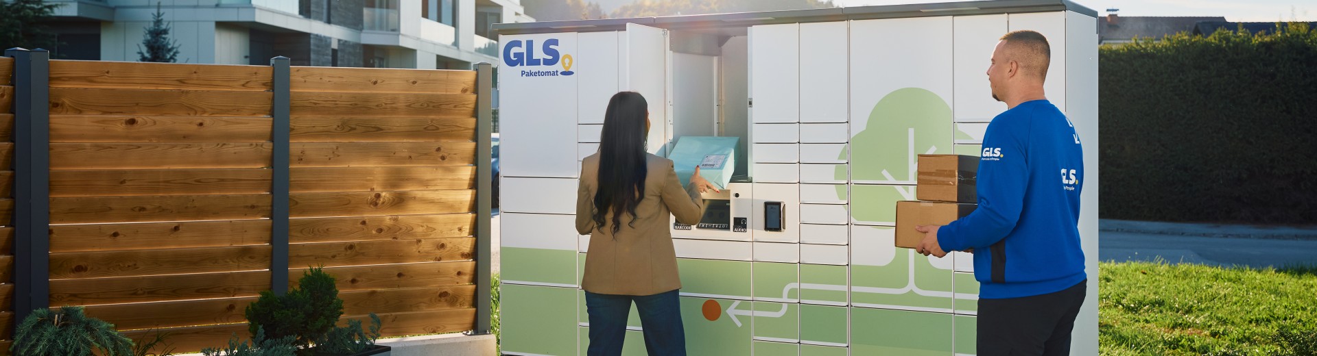 Customer and GLS courier in front of a Parcel Locker